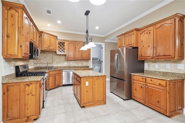 kitchen with pendant lighting, a center island, tasteful backsplash, sink, and appliances with stainless steel finishes