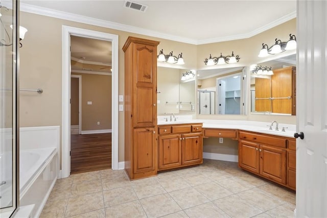 bathroom featuring independent shower and bath, ornamental molding, vanity, and tile patterned floors