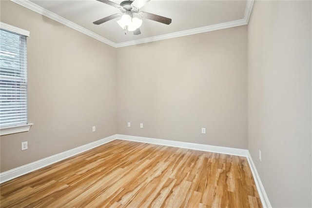 empty room with ornamental molding, wood-type flooring, and ceiling fan