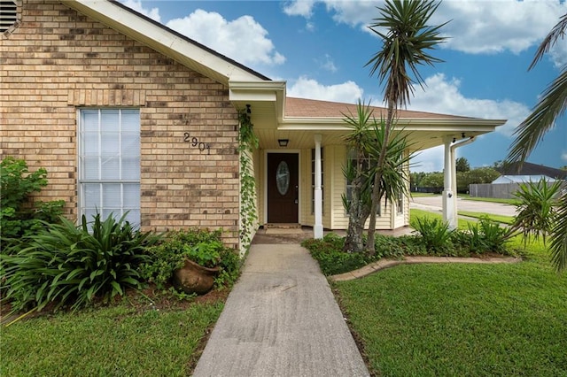 doorway to property featuring a yard