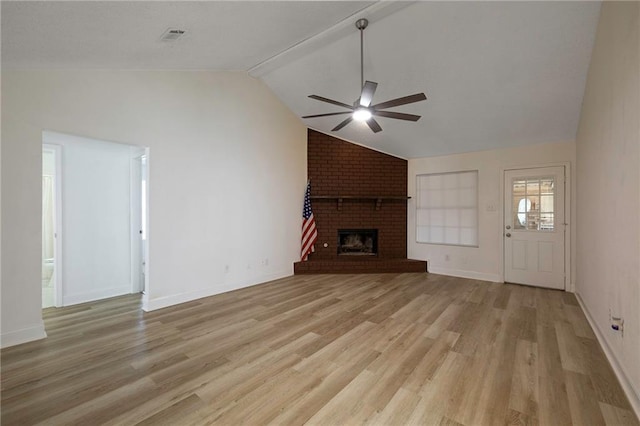 unfurnished living room with light wood-type flooring, ceiling fan, a brick fireplace, and vaulted ceiling