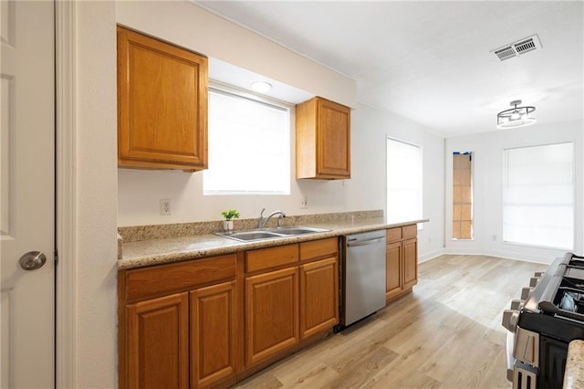 kitchen featuring appliances with stainless steel finishes, light hardwood / wood-style floors, and sink