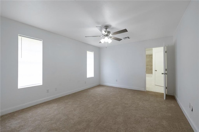 unfurnished room featuring ceiling fan and light carpet