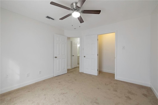 unfurnished bedroom with light colored carpet and ceiling fan