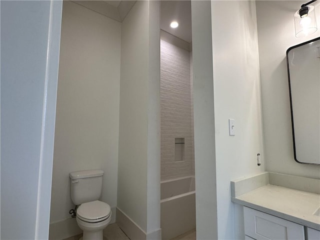 bathroom featuring vanity, a washtub, and toilet