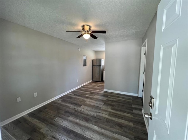 spare room with ceiling fan, a textured ceiling, dark wood-type flooring, and electric panel