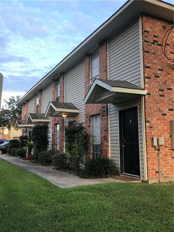 view of front of house with a front yard and brick siding