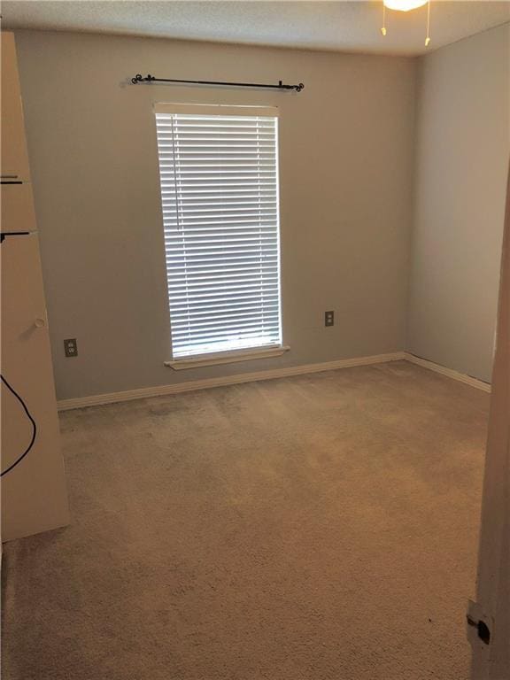 spare room with carpet floors and baseboards