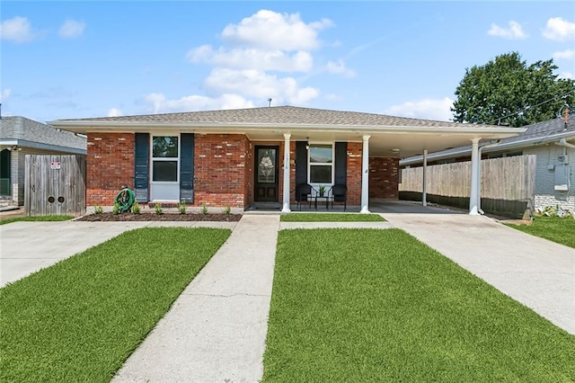 view of front of house with a front lawn and a carport