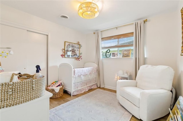 interior space featuring light wood-type flooring and a crib