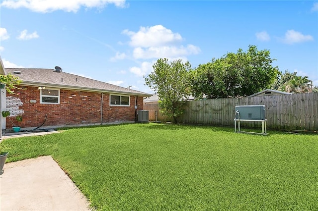 view of yard featuring central AC unit and a patio area