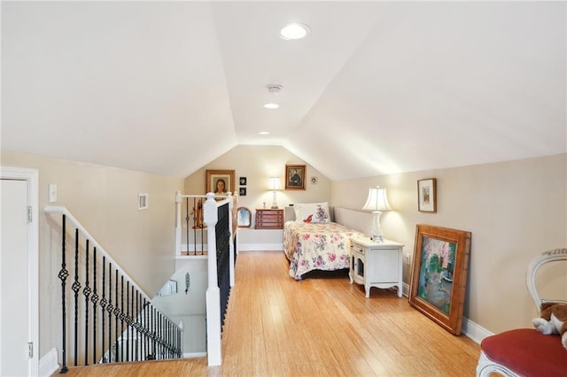 bedroom with lofted ceiling and light hardwood / wood-style flooring