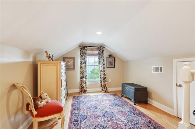 additional living space with lofted ceiling and light hardwood / wood-style floors