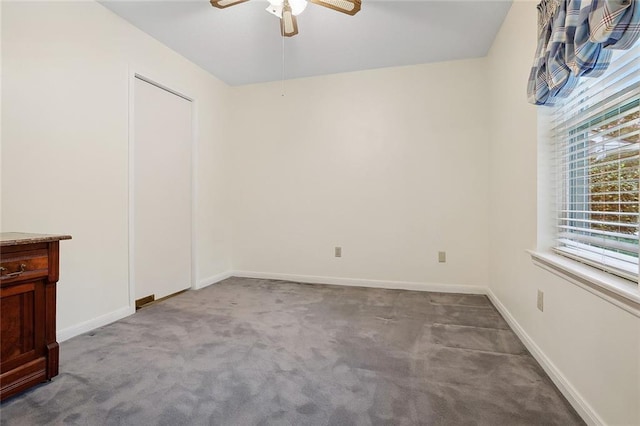 interior space with a ceiling fan, baseboards, and carpet flooring