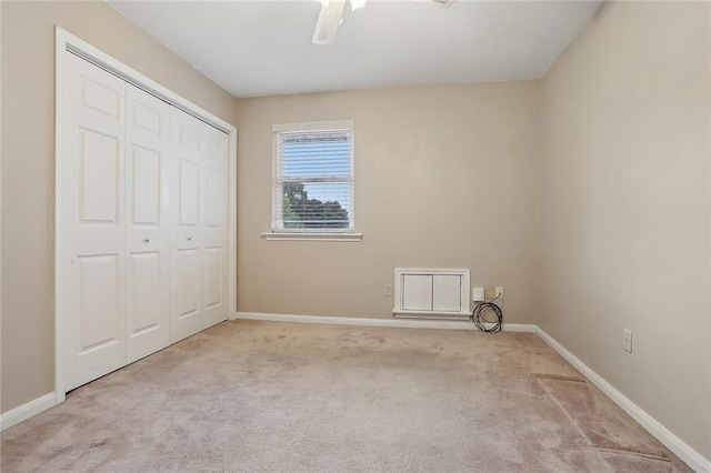 unfurnished bedroom featuring ceiling fan, carpet floors, a closet, and baseboards