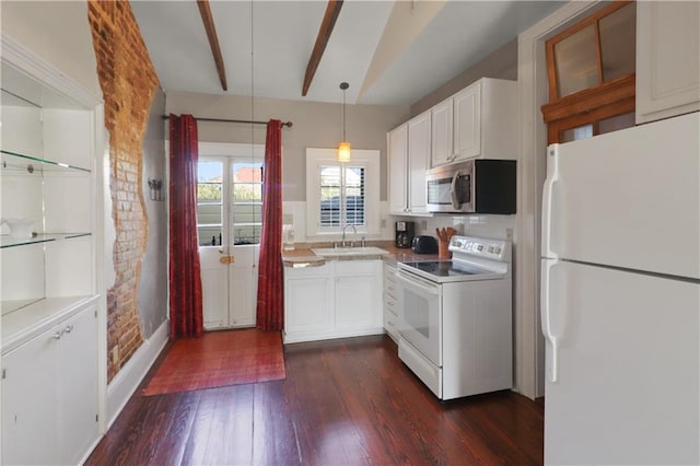 kitchen featuring pendant lighting, sink, white appliances, white cabinetry, and dark hardwood / wood-style floors