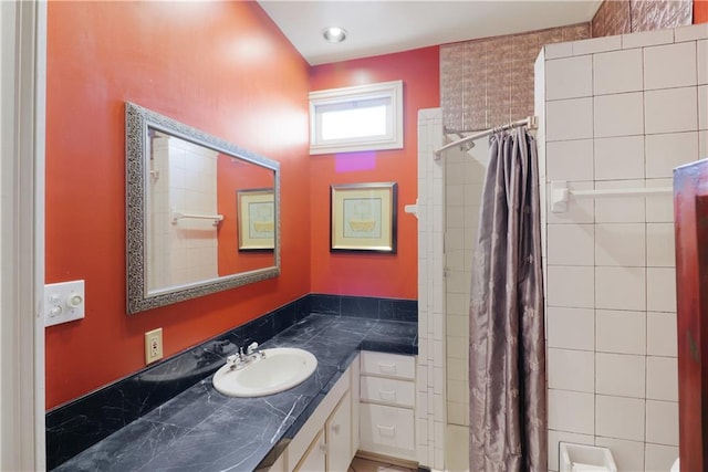 bathroom featuring vanity and curtained shower