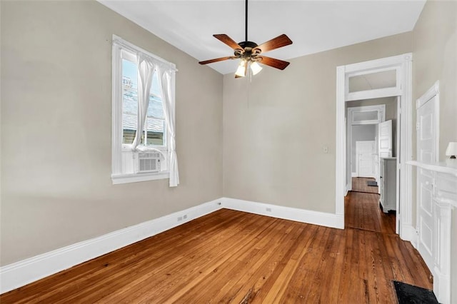 unfurnished bedroom featuring wood-type flooring, a ceiling fan, and baseboards