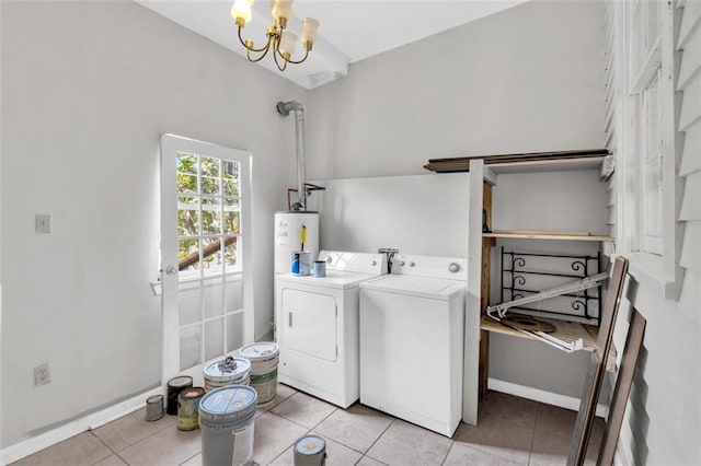 washroom featuring light tile patterned floors, gas water heater, laundry area, baseboards, and washer and dryer