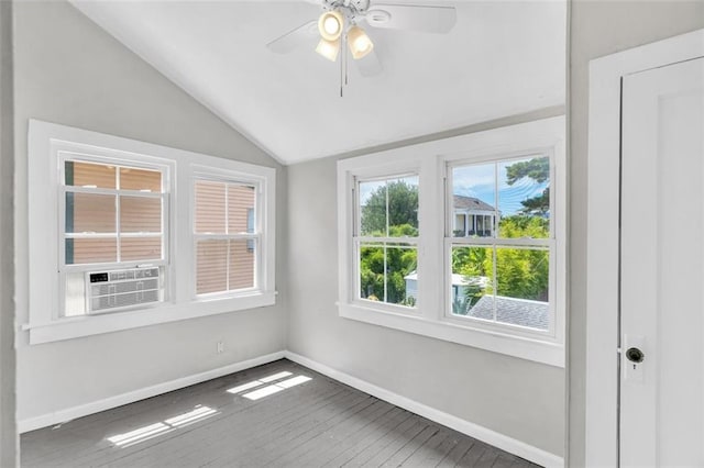 unfurnished room featuring wood-type flooring, vaulted ceiling, ceiling fan, cooling unit, and baseboards