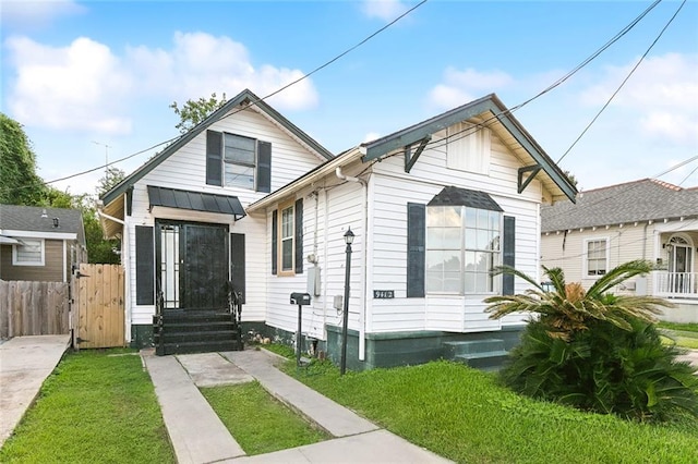 bungalow-style house featuring a front lawn