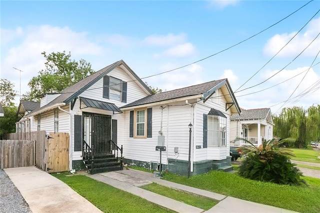 bungalow-style house featuring a front yard