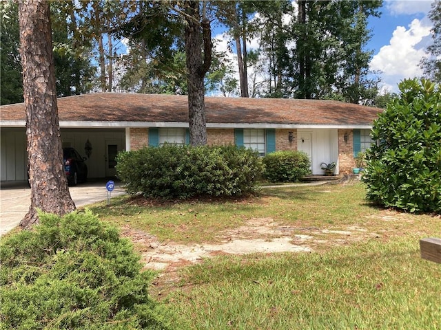 ranch-style house featuring a carport and a front yard