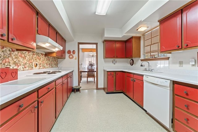 kitchen featuring white appliances, sink, and an inviting chandelier