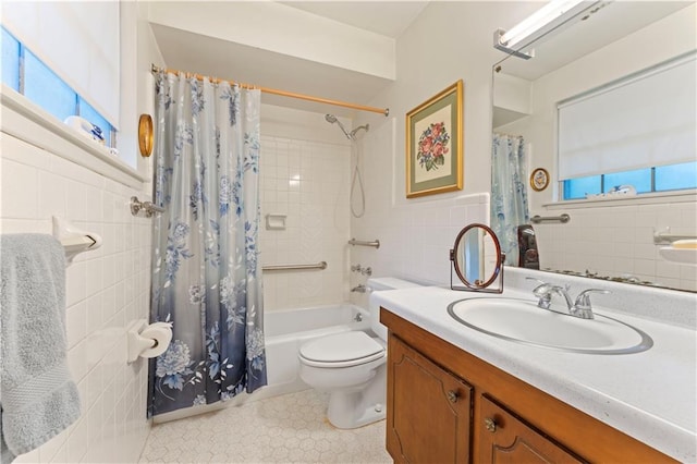 full bathroom with shower / bath combo, vanity, toilet, and tile walls