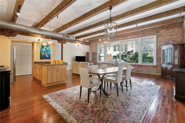 dining room with dark hardwood / wood-style flooring, a notable chandelier, brick wall, rail lighting, and beam ceiling