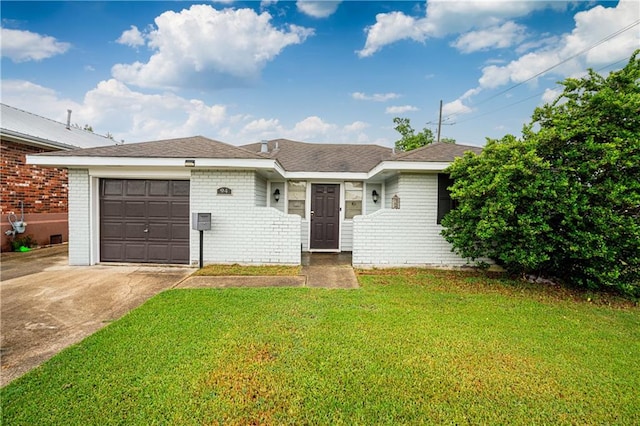 ranch-style house featuring a garage and a front yard