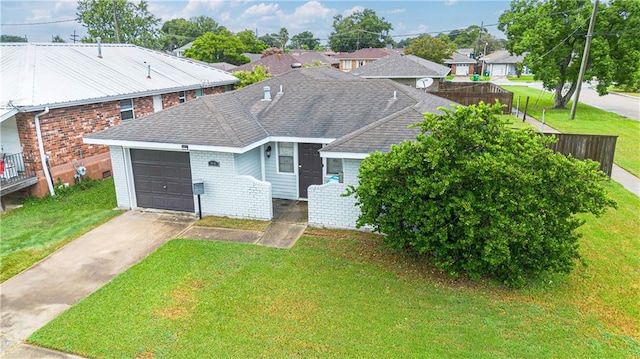 view of front of property with a garage and a front yard