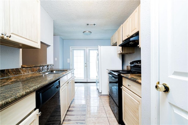 kitchen featuring visible vents, under cabinet range hood, black appliances, a sink, and light tile patterned flooring