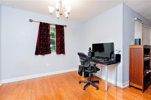 office with a notable chandelier, a textured ceiling, baseboards, and wood finished floors