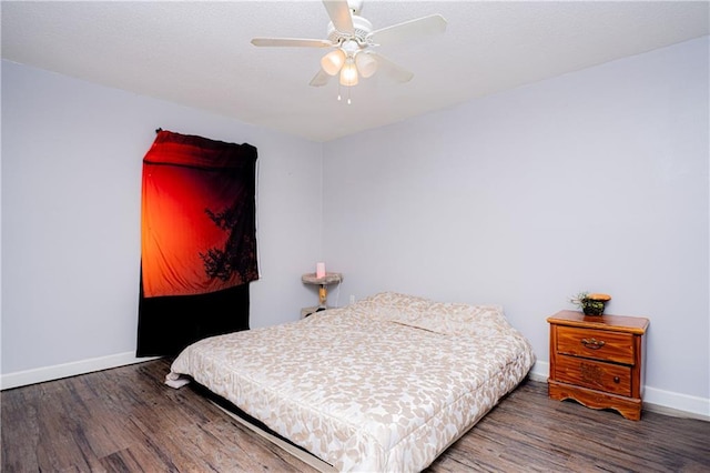 bedroom featuring baseboards and wood finished floors