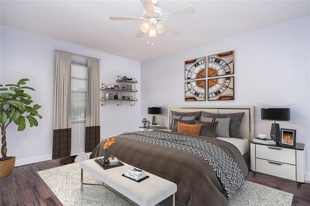 bedroom with wood finished floors, a ceiling fan, and baseboards