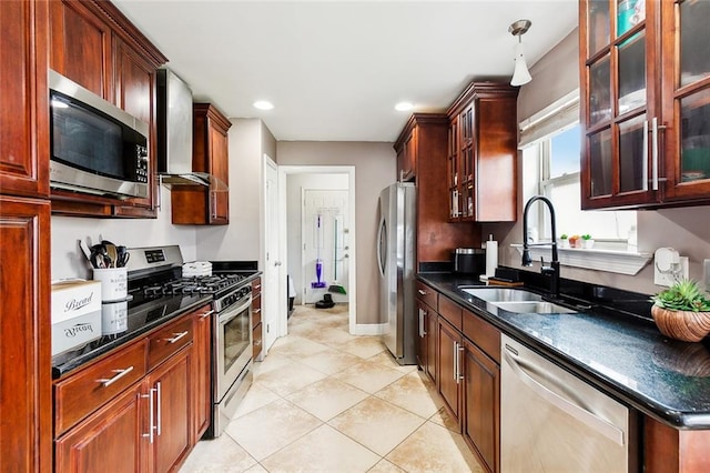 kitchen featuring appliances with stainless steel finishes, sink, wall chimney exhaust hood, light tile patterned flooring, and pendant lighting