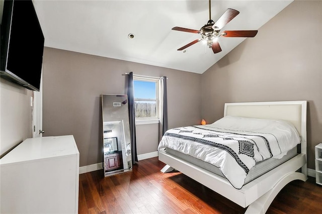 bedroom with ceiling fan, dark hardwood / wood-style floors, and vaulted ceiling