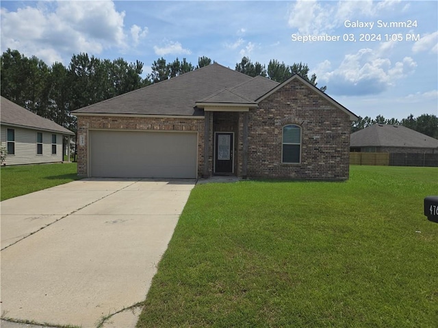 view of front of property with a garage and a front yard