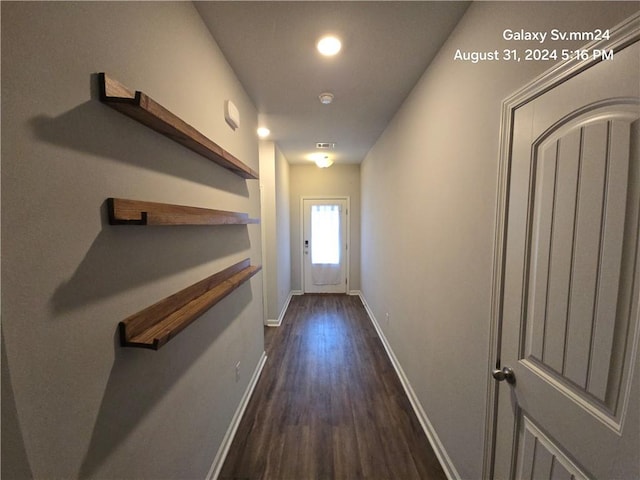 hallway with dark hardwood / wood-style flooring