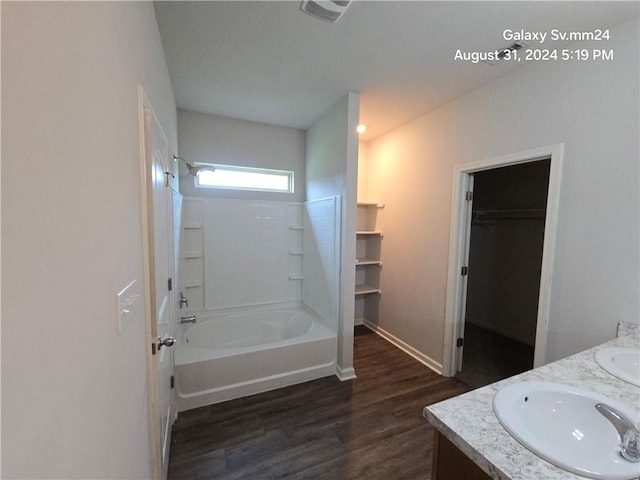 bathroom with vanity, hardwood / wood-style flooring, and shower / bathtub combination