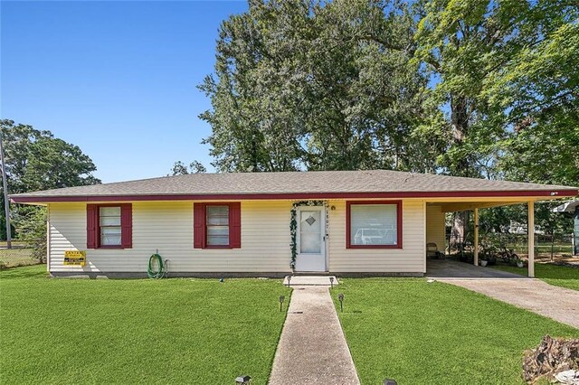 ranch-style home featuring a carport and a front yard