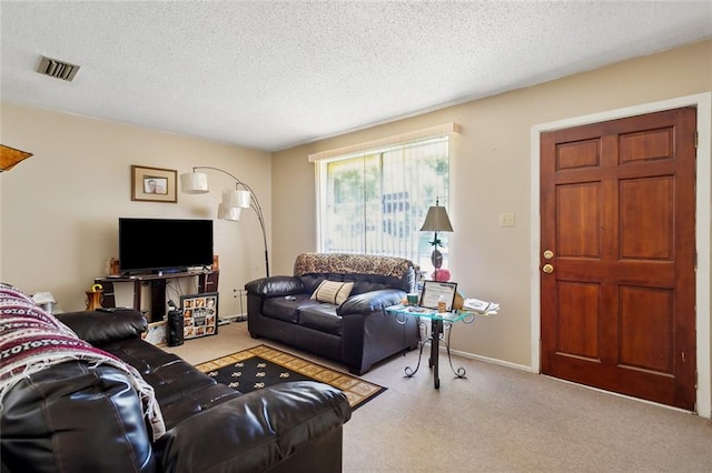 carpeted living room with a textured ceiling