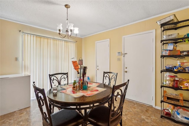 dining area featuring ornamental molding, a chandelier, and a textured ceiling