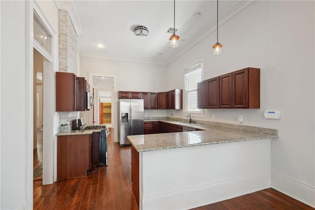 kitchen with ornamental molding, decorative light fixtures, stainless steel appliances, sink, and dark hardwood / wood-style floors