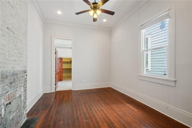 empty room featuring crown molding, dark wood-type flooring, and ceiling fan