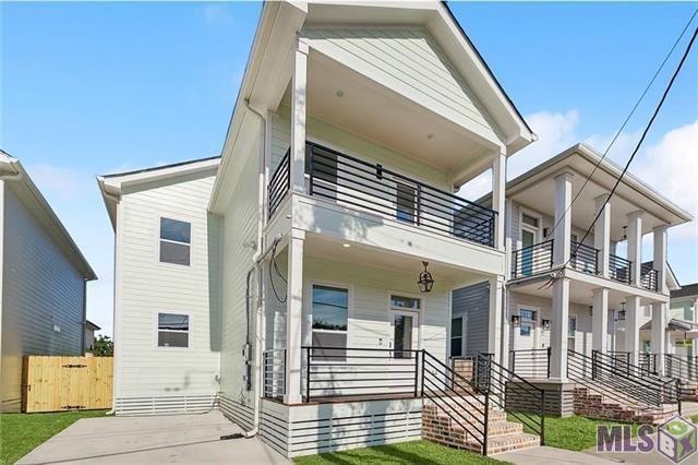 view of front of property featuring a balcony and covered porch