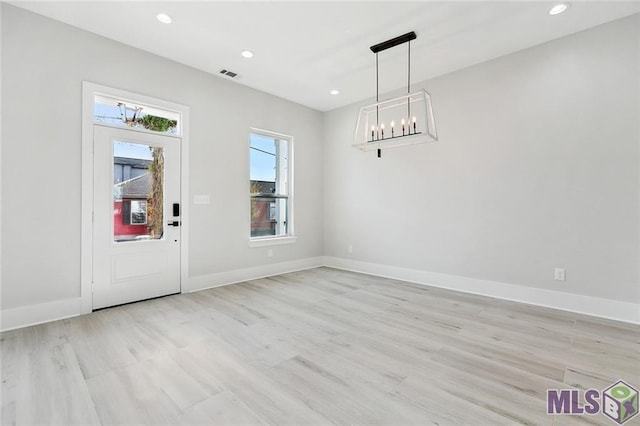 unfurnished dining area featuring light wood-type flooring