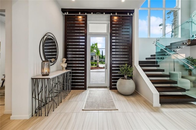 foyer entrance featuring light wood-type flooring and a wealth of natural light