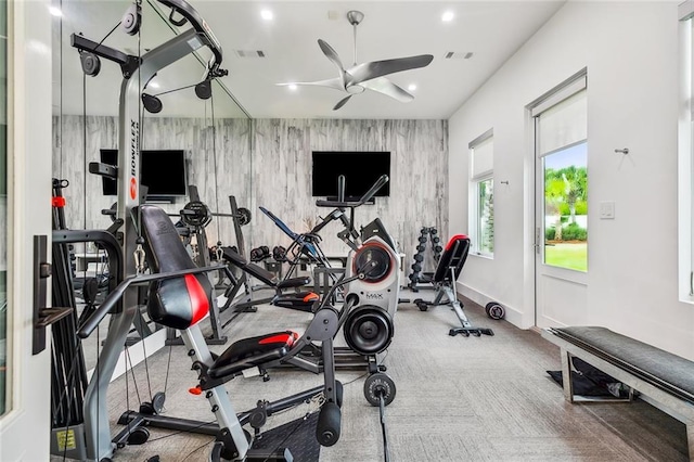 exercise area featuring ceiling fan and light colored carpet